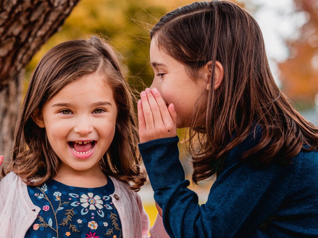 a girl whispering